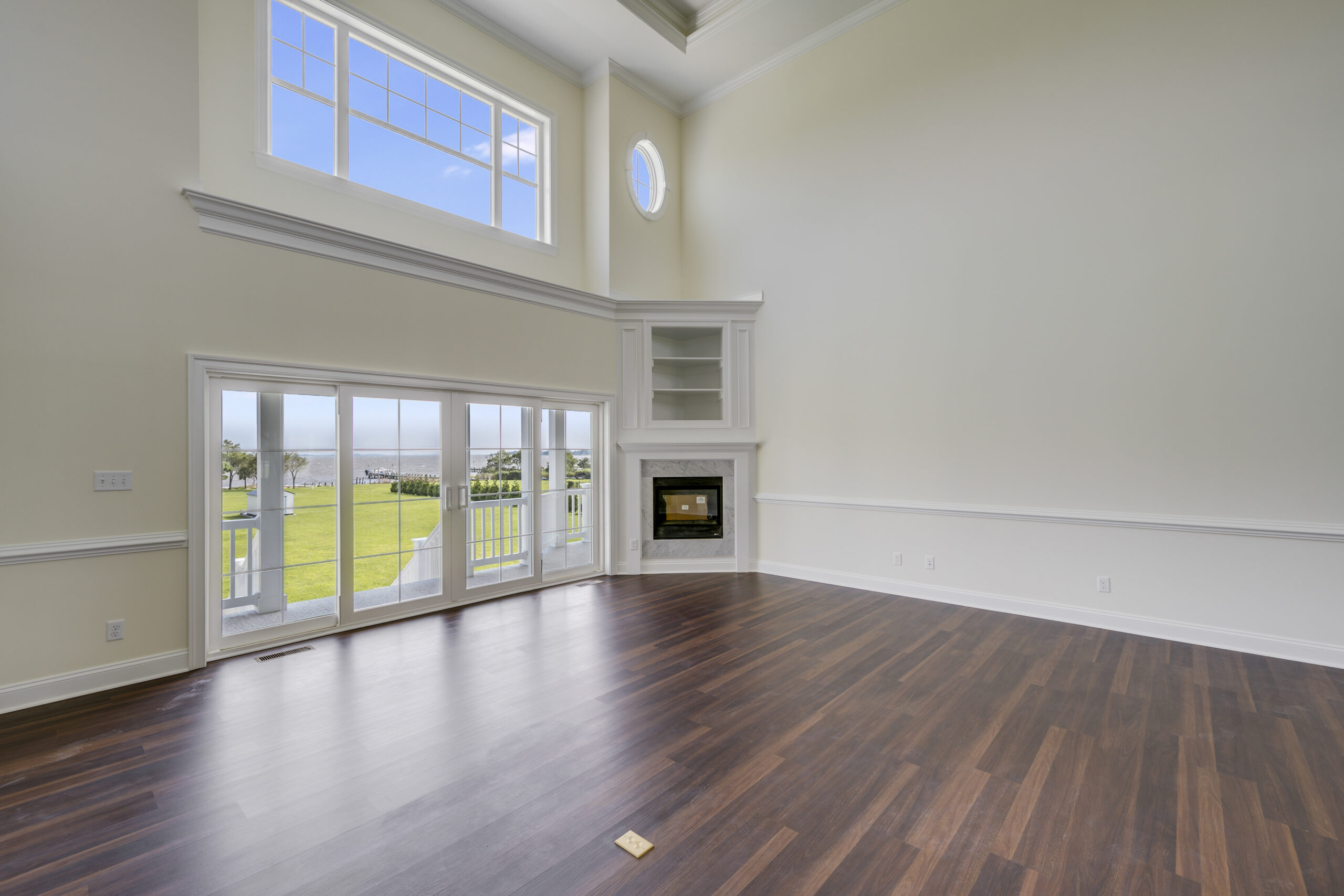 an empty living room with hard wood floors