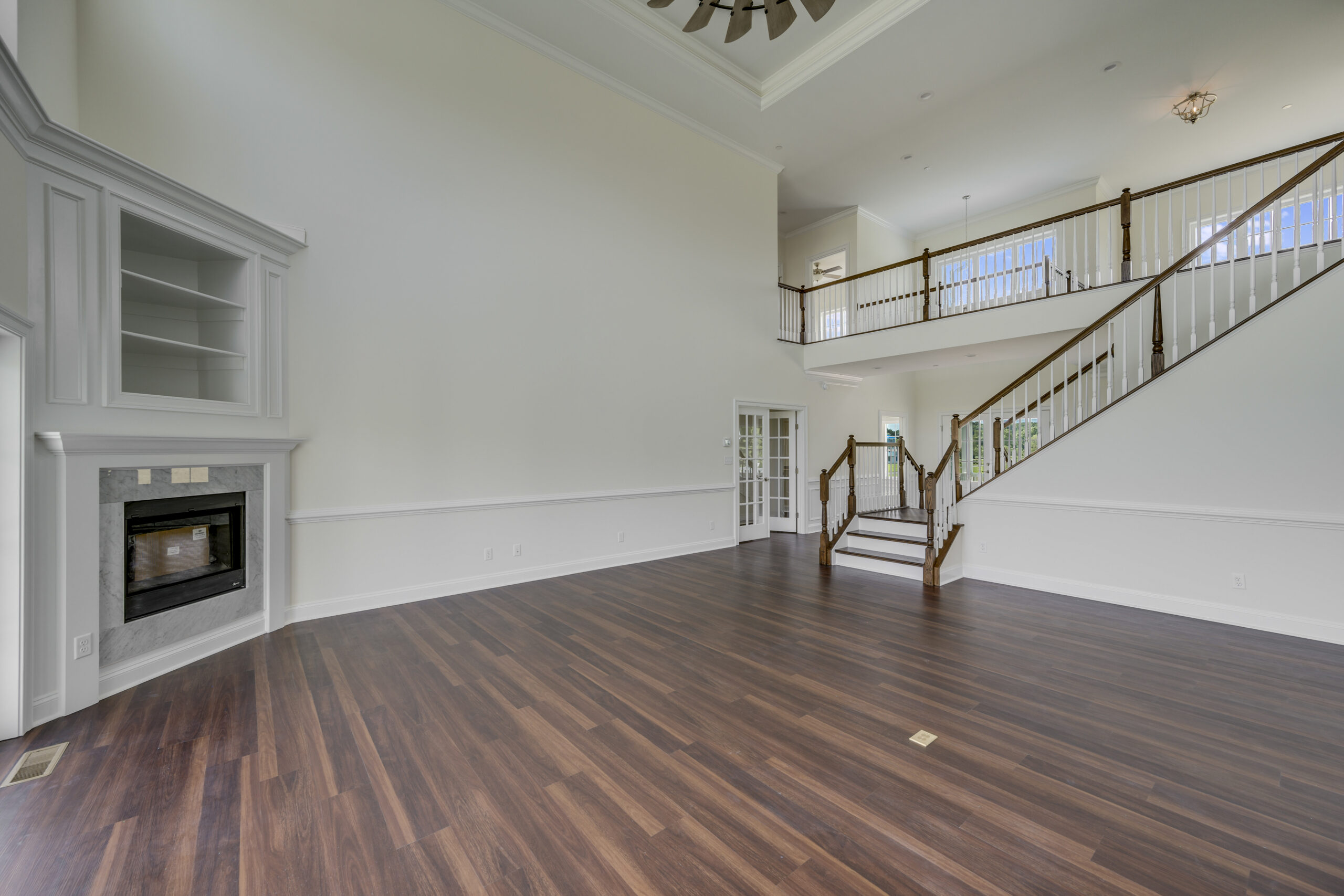 a large empty living room with a fireplace