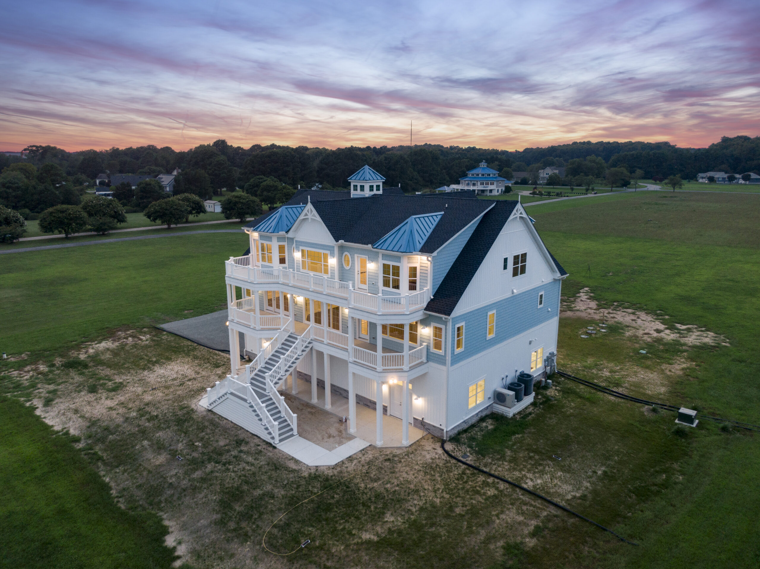 a large white house with a blue roof
