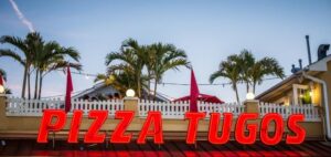 a sign that says pizza tugos in front of a restaurant