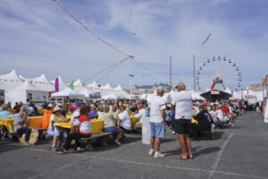 a crowd of people standing around a carnival tent