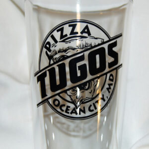 a close up of a pint glass with a logo on it