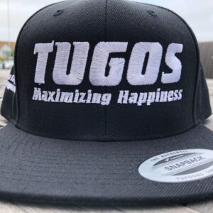 a black and white hat sitting on top of a wooden table