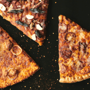three slices of pizza sitting on top of a table