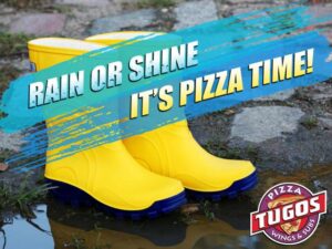 a pair of yellow rain boots sitting on top of a puddle