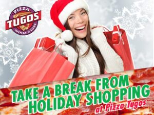 a woman in a santa hat holding a bag of pizza