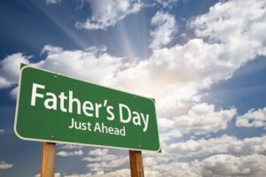 a green sign that says father's day just ahead
