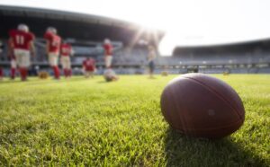 a football sitting on top of a lush green field