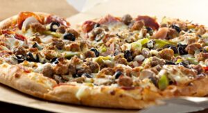 a pizza sitting on top of a wooden table