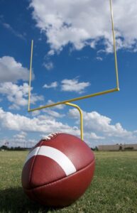 a football sitting on top of a lush green field