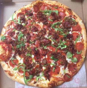 a pizza sitting in a box on top of a table