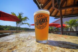 a glass of beer sitting on top of a table