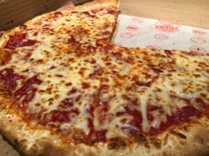 a pepperoni pizza sitting in a box on a table