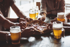 a group of people sitting around a wooden table