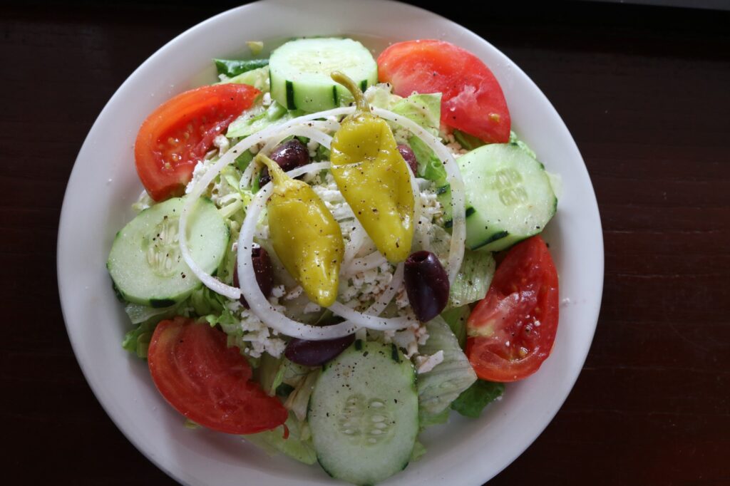 Primo Family Restaurant greek salad with pepperoncini's, olives, onion, cucumber, and tomato