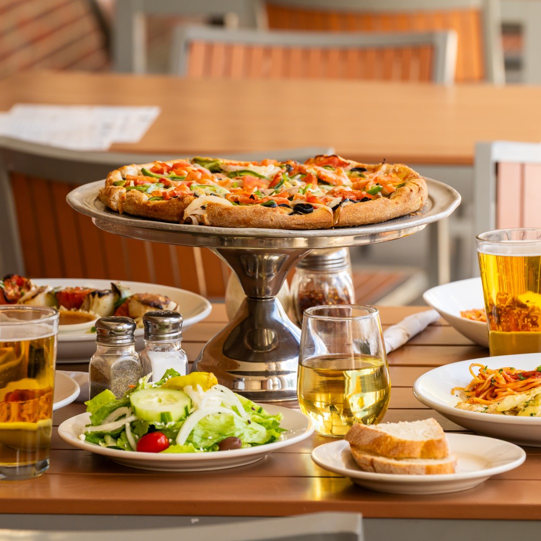 Primo Family Restaurant veggie pizza with wine, bread, salad, and beer