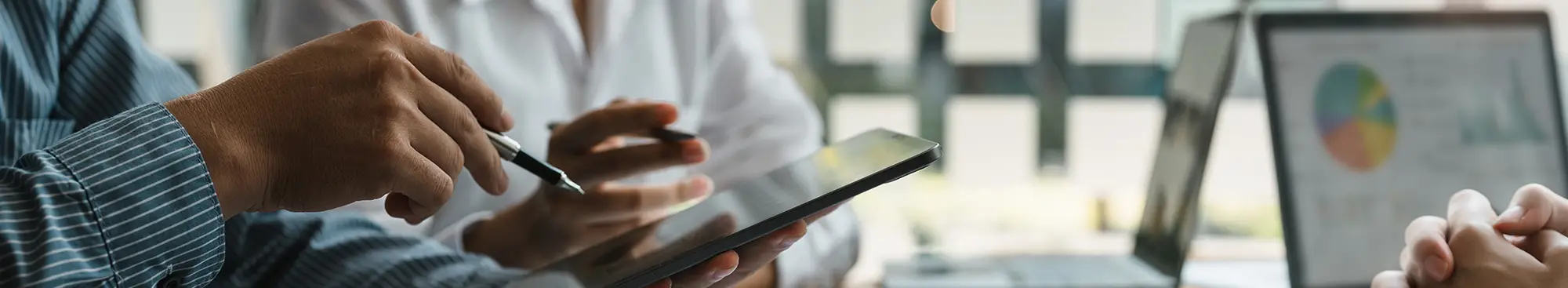 two people working with laptops and tablets