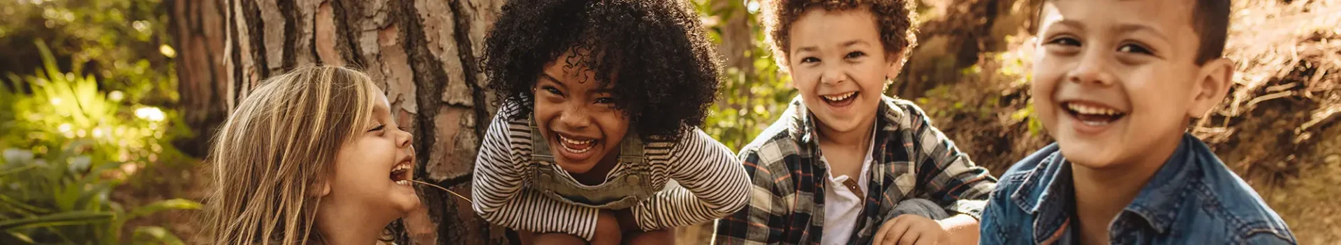 4 kids outside smiling