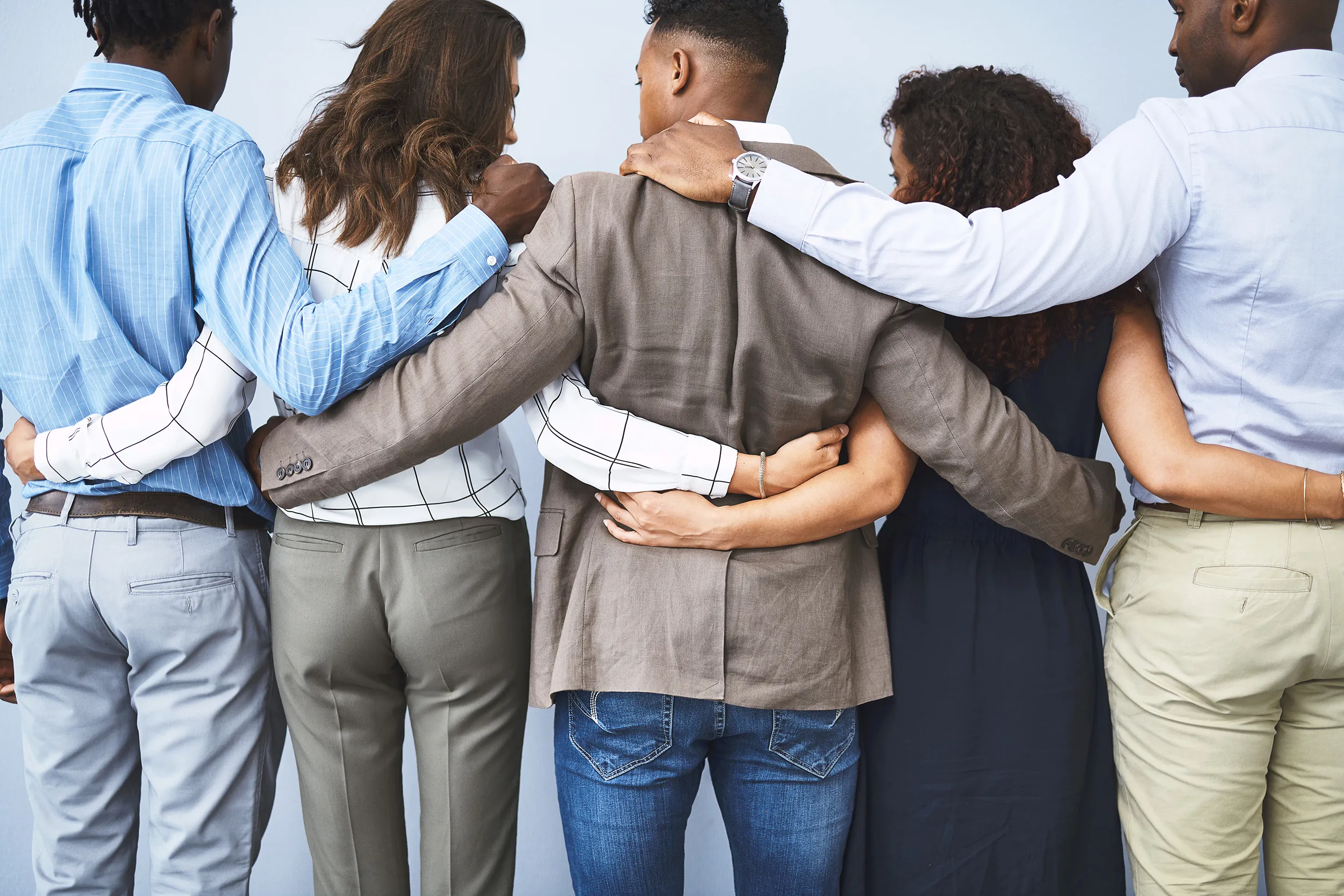 5 people having their arms around each other