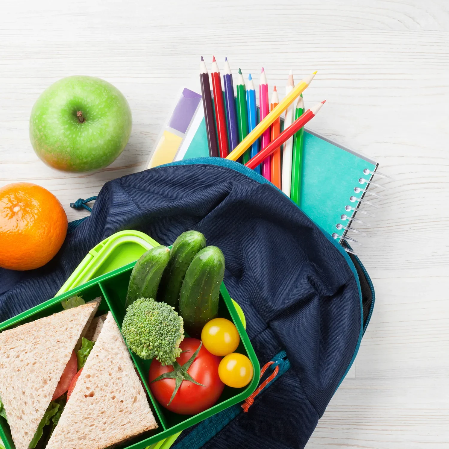 backpack with lunch box and notebook and colored pencils