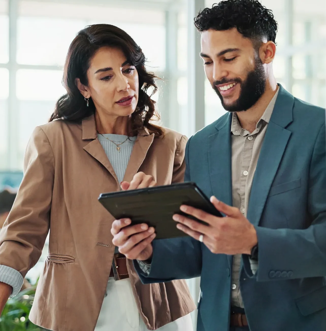 man and woman looking at a tablet