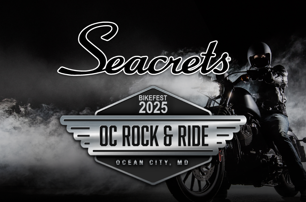a man riding a motorcycle on a dark background