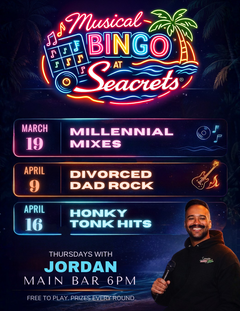 a man standing in front of a neon sign