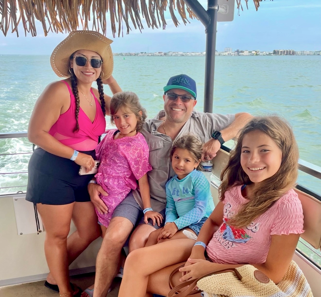 a group of people on a boat posing for a picture