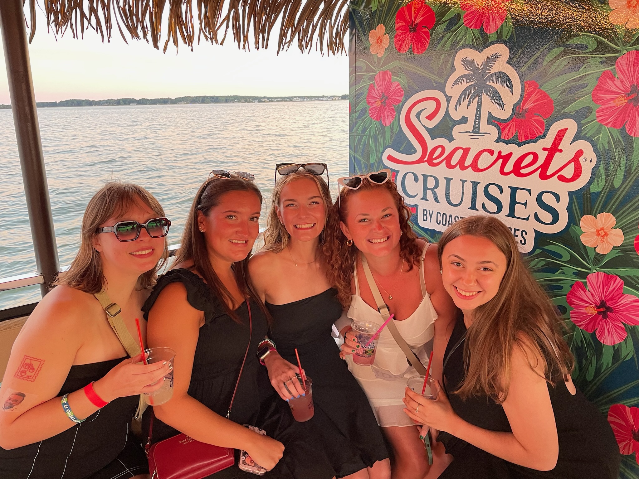 a group of girls posing for a picture in front of a sign