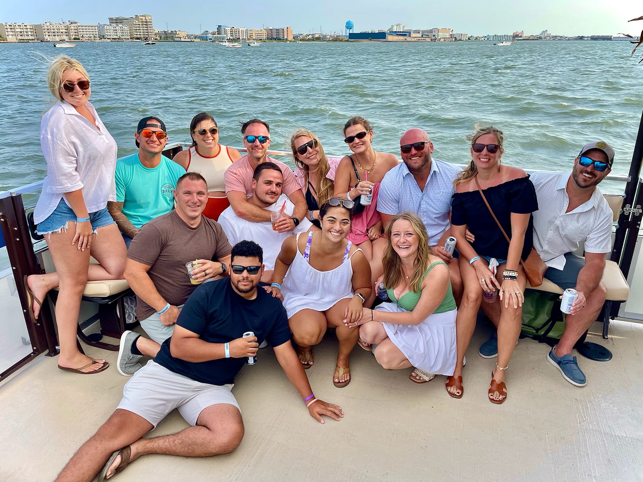 a group of people on a boat posing for a picture