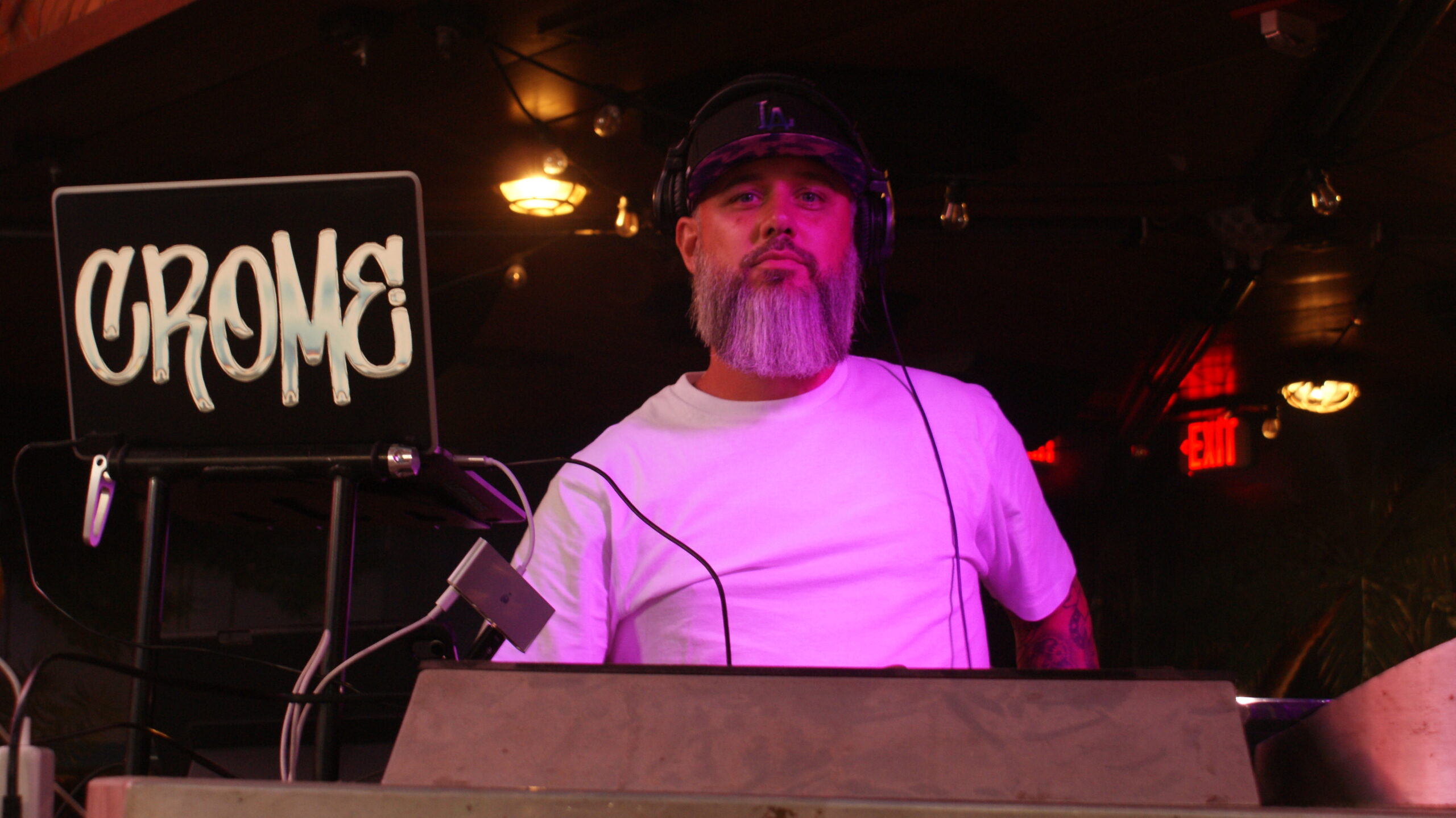 a man with a beard standing behind a keyboard