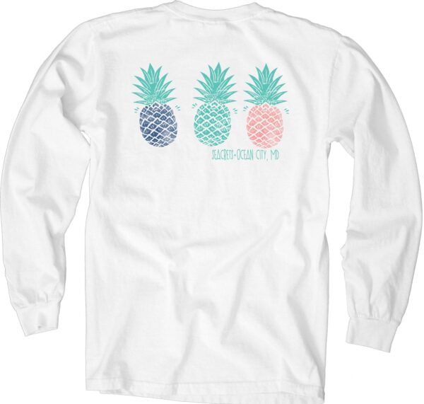 a white shirt with three pineapples on it