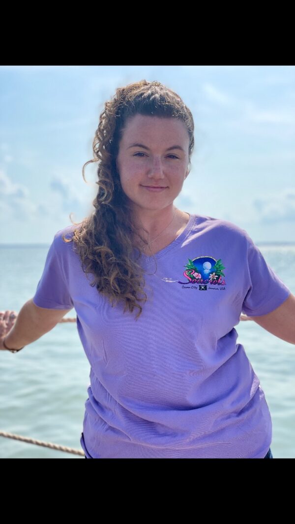 a woman standing on a boat in the ocean