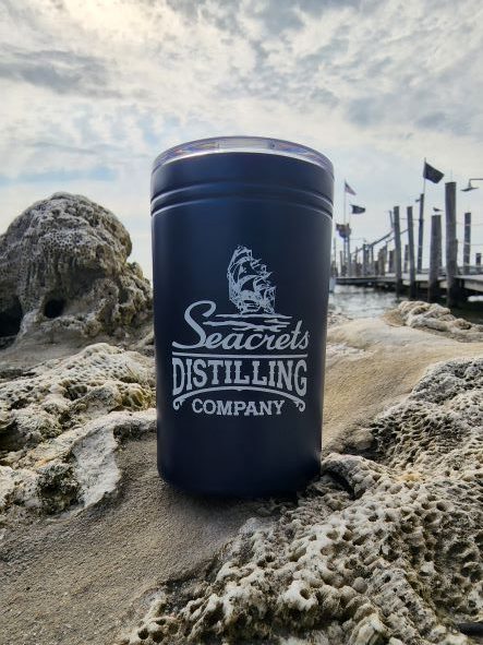 a can of distilling company sitting on a beach