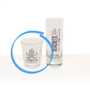 a shot glass and a shot glass sitting on a table