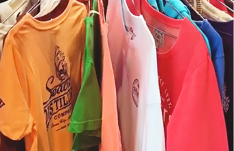 a rack of shirts hanging on a clothes rack