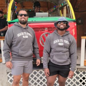 two men standing in front of a truck