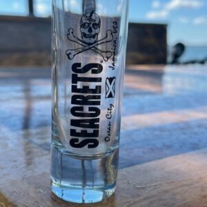 a glass bottle sitting on top of a wooden table