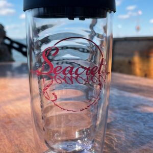 a close up of a water bottle on a wooden surface