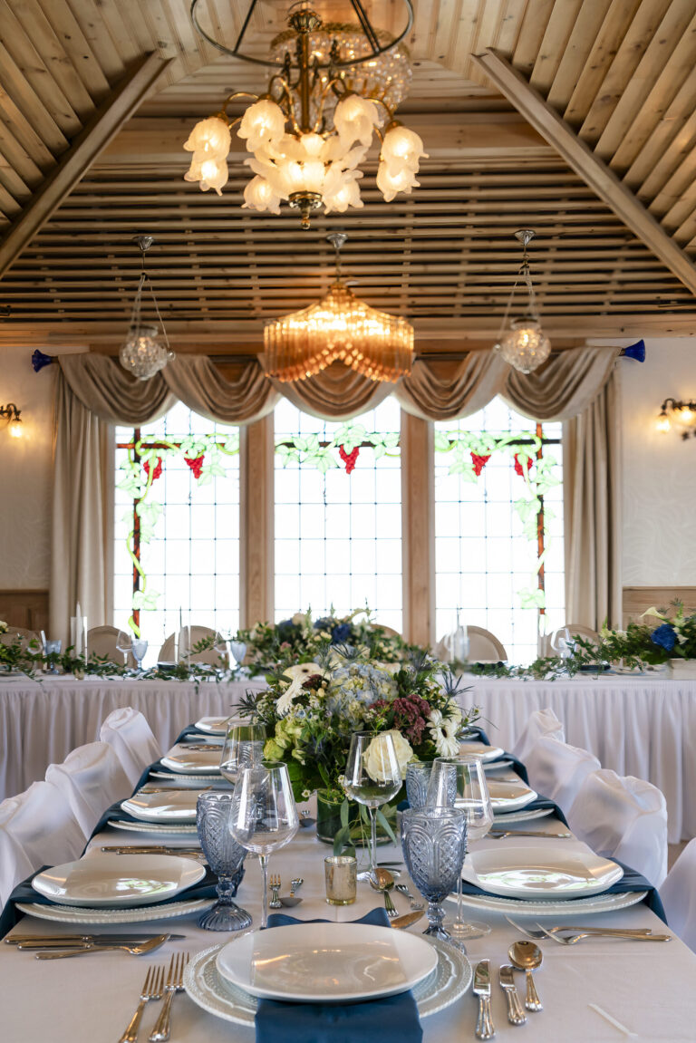 a table set for a formal dinner in a banquet hall