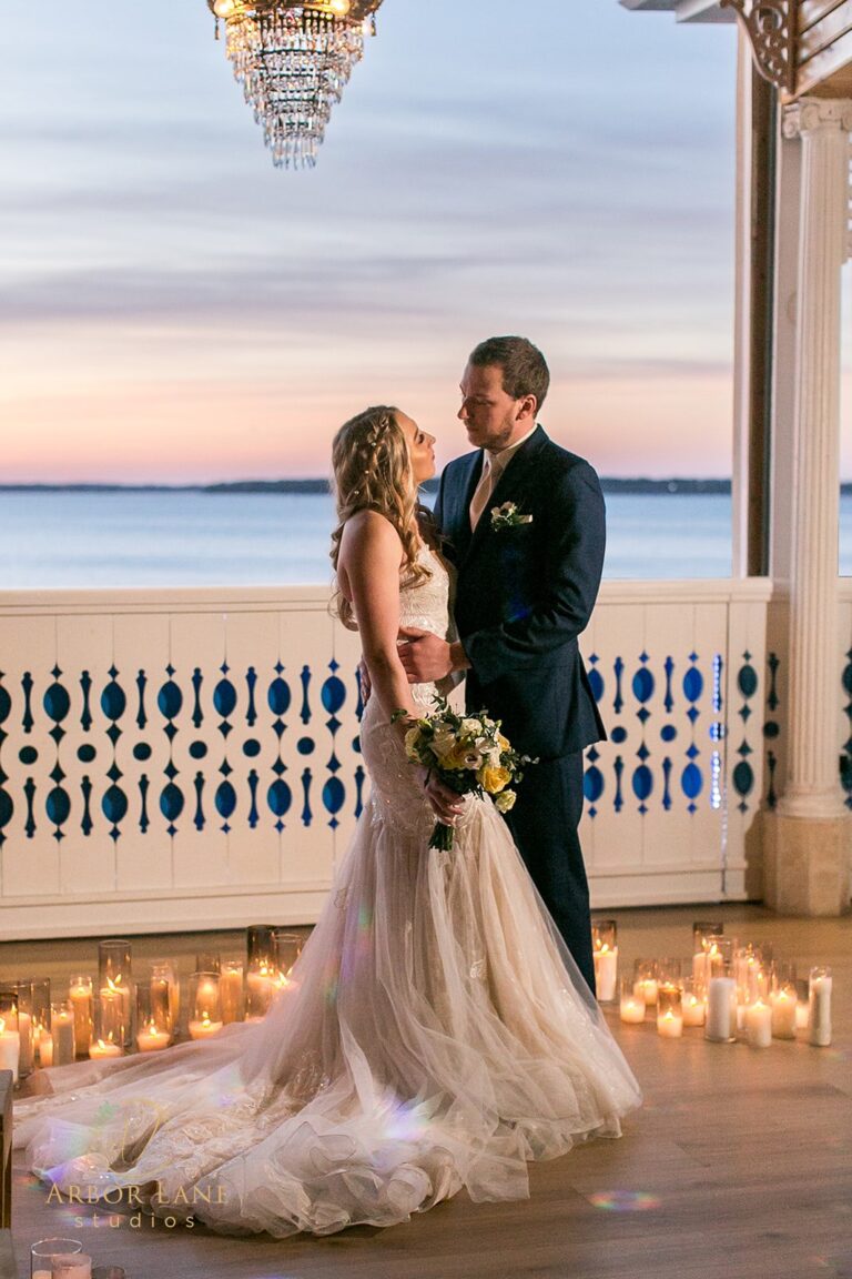 a bride and groom standing in front of a gazebo