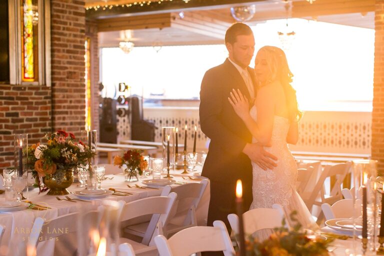a bride and groom standing in front of a table