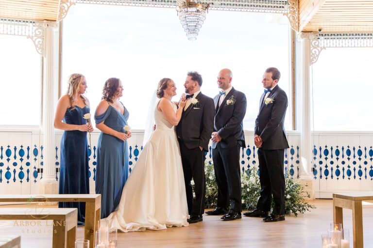 a bride and groom standing in front of their wedding party