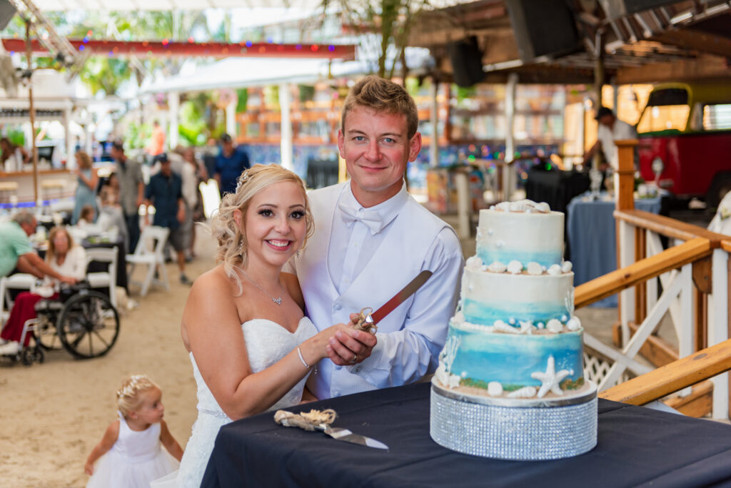 a bride and groom cutting their wedding cake