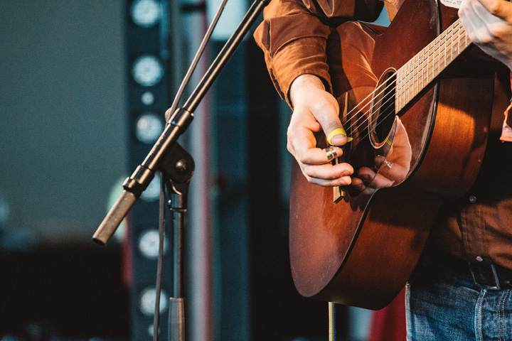 a singer on stage playing guitar