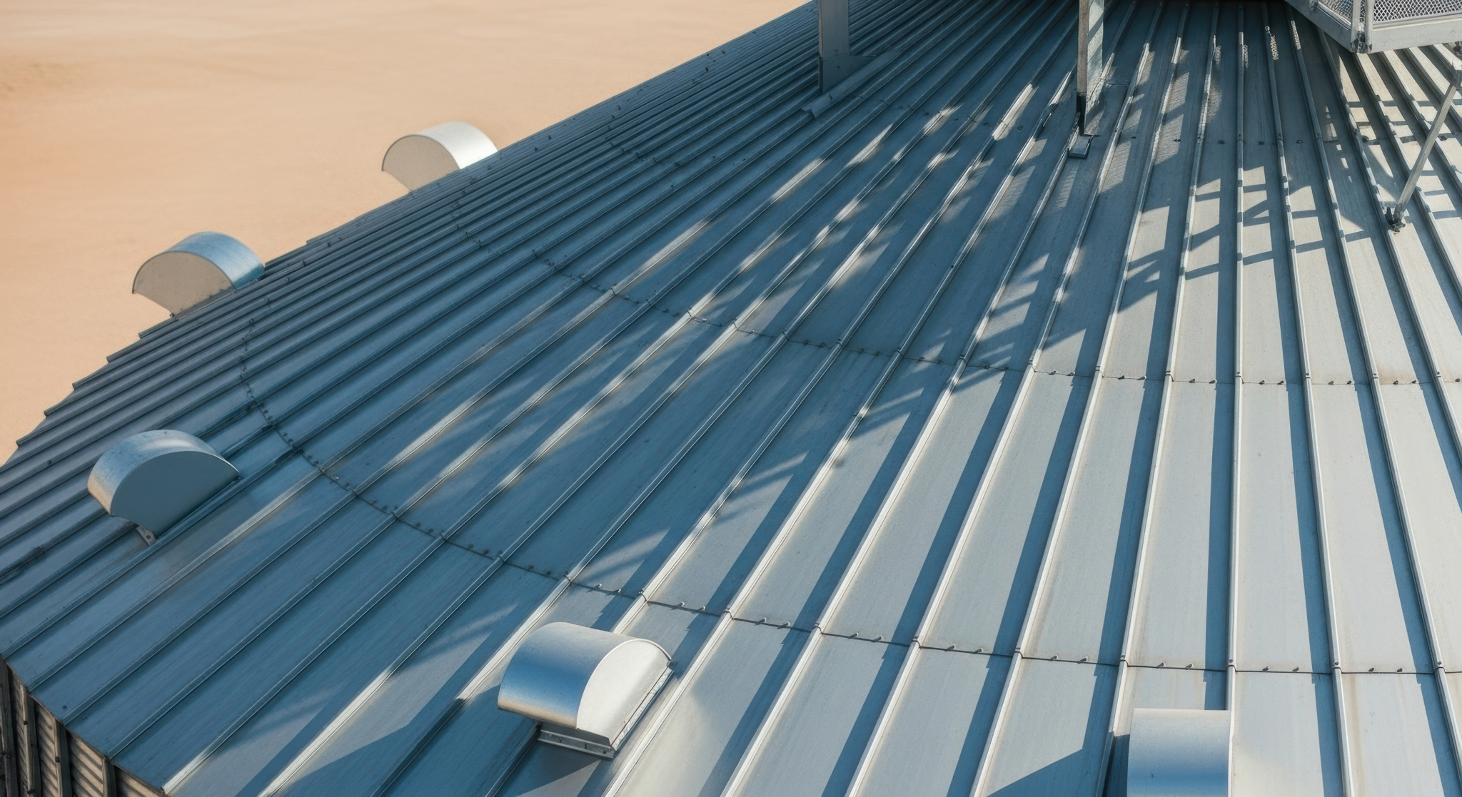 a metal roof with a wind vane on top of it