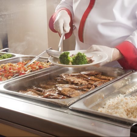chef standing behind full lunch service station