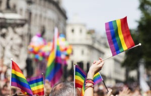 a group of people holding rainbow flags in the street
