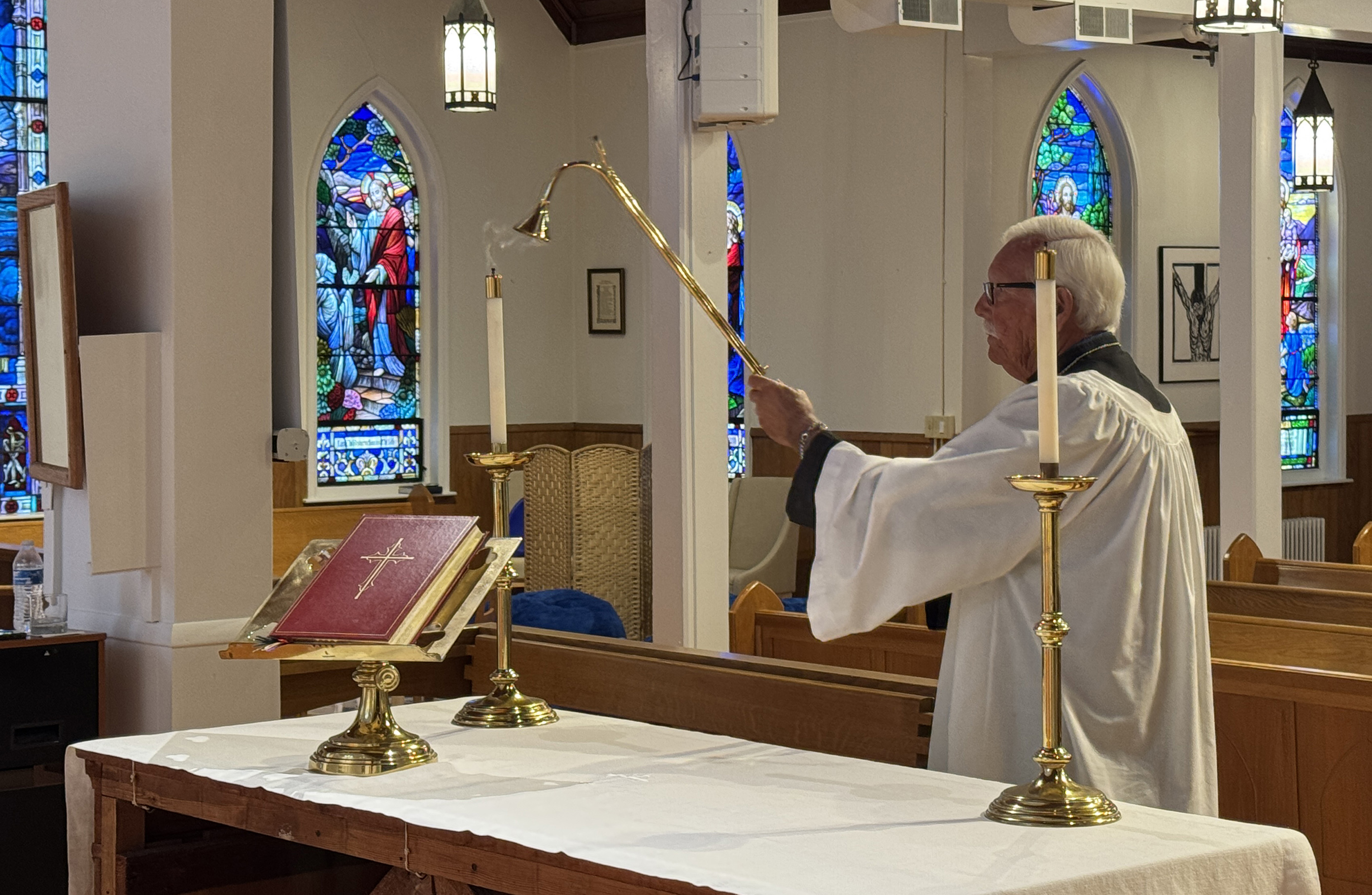 Acolyte extinguishing candles