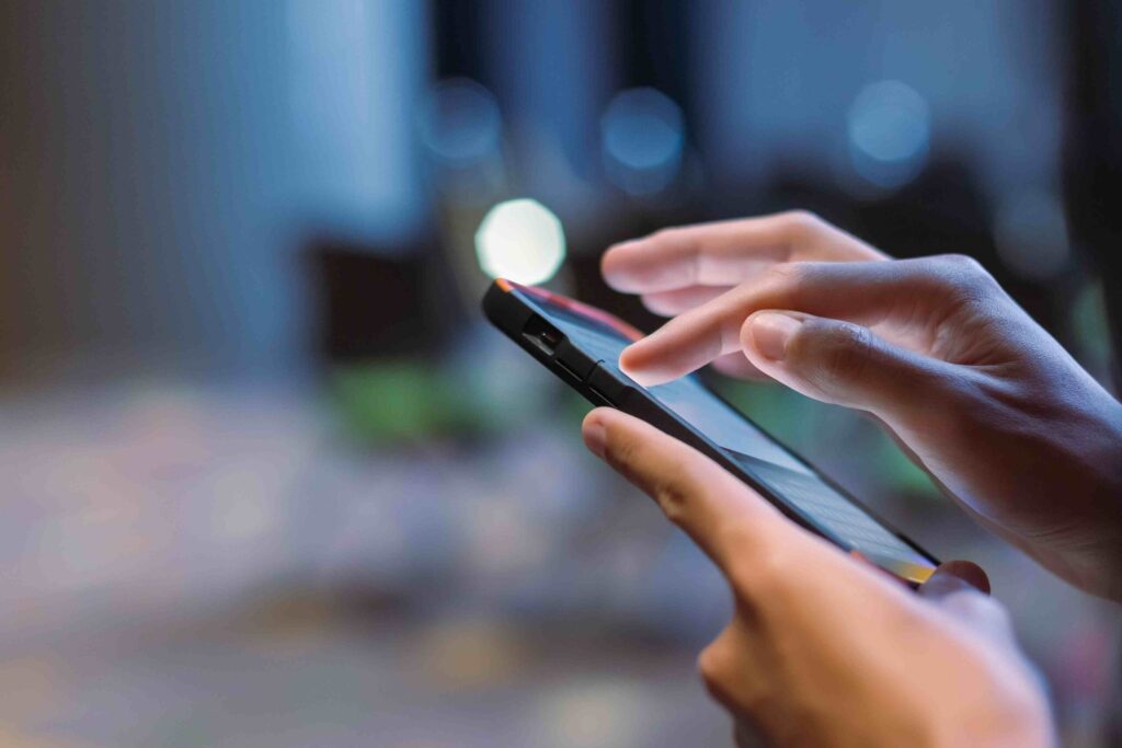 close up of person tapping on mobile phone
